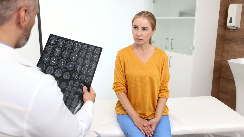 Physician discussing brain imaging results with patient following stroke symptoms