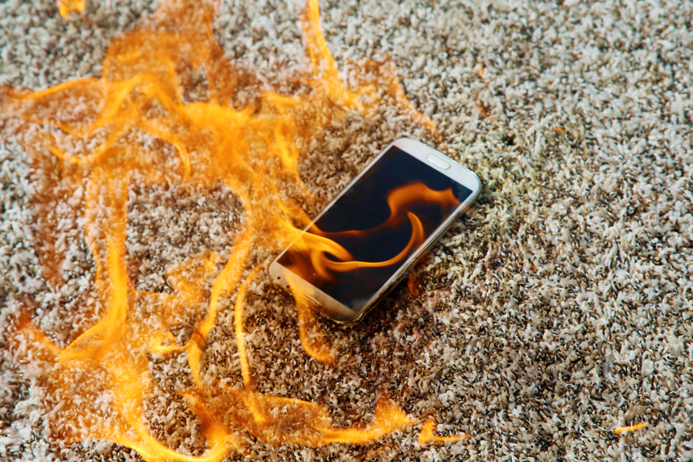 Smartphone on fire illustrating dangers of the fire breathing social media trend and viral challenges causing severe burn injuries
