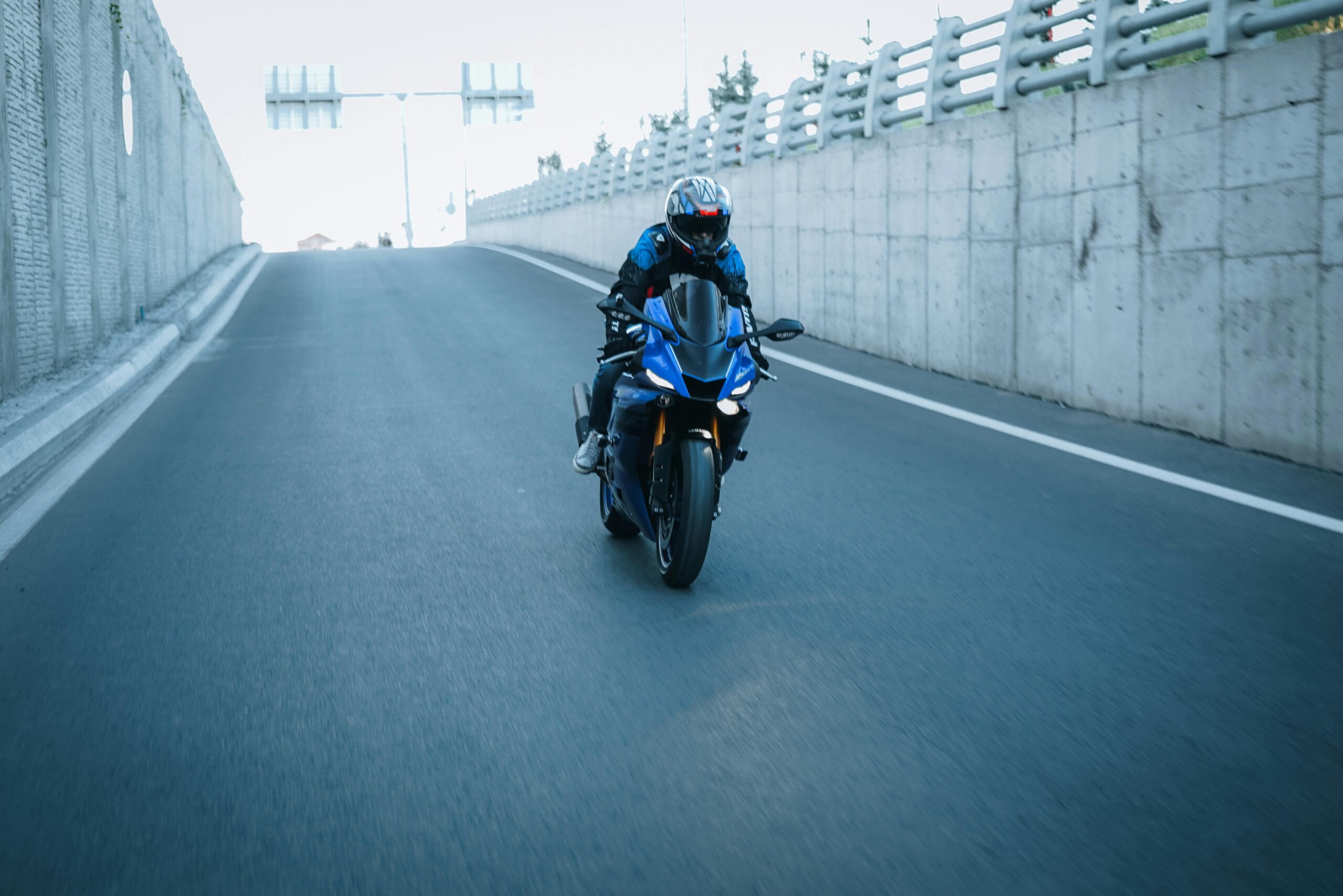Motorcycle accident awareness image showing a rider on a New Jersey roadway after a crash risk scenario.